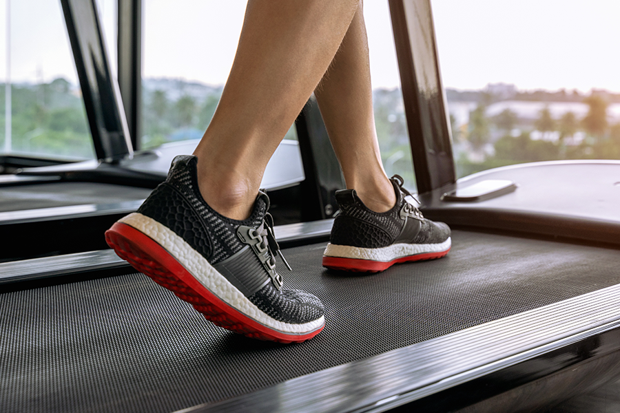 Close-up of a woman's feet as she exercises on a treadmill