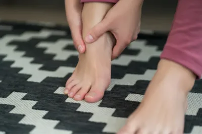 Person massaging their own feet